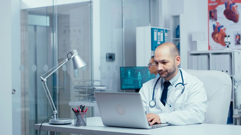 Doctor typing an e-mail