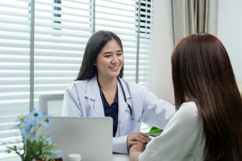 Friendly Female Doctor Consulting with Patient in Modern Medical Office