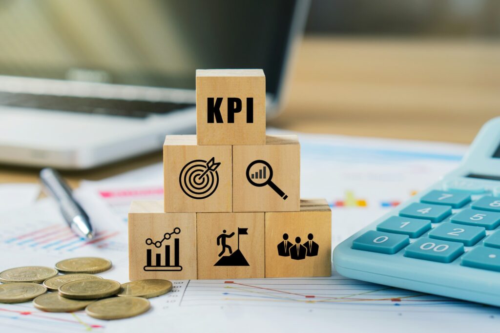 KPI, Key Performance Indicator.KPI icon on wooded cube o a board room table.